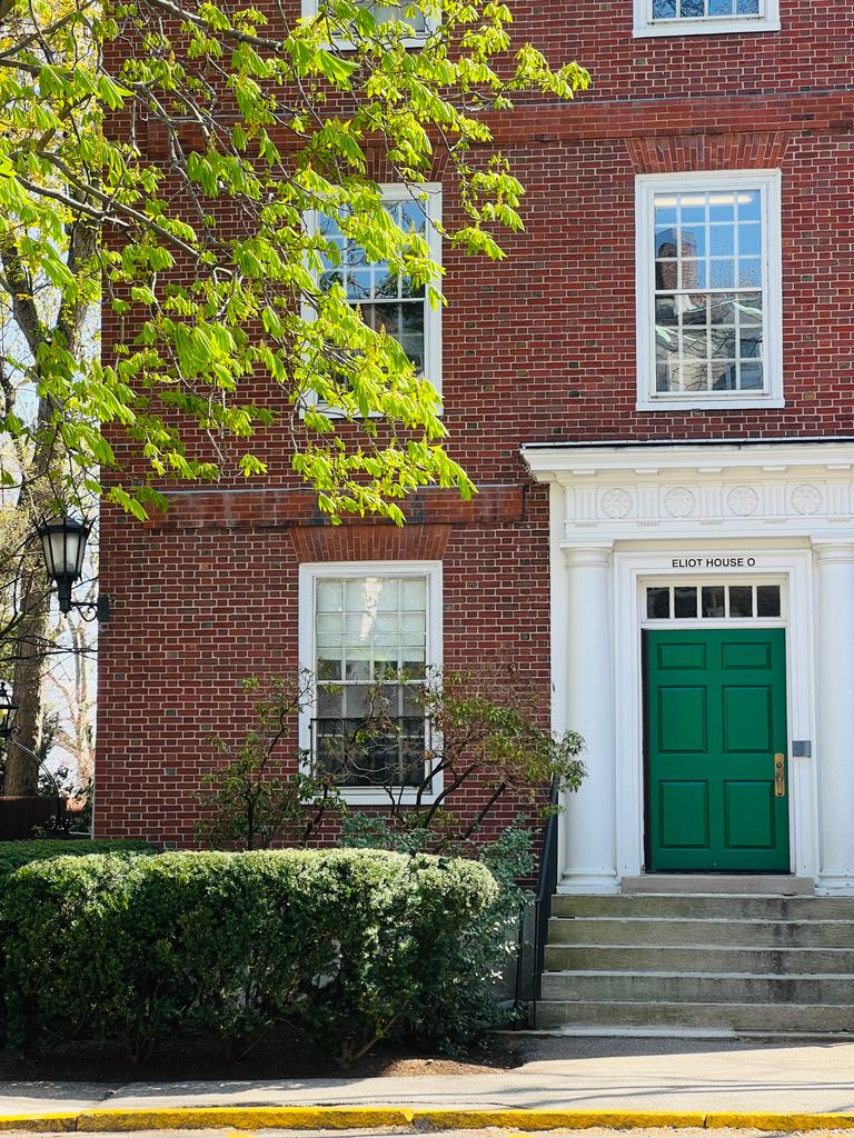 Charming brick facade with green door at Eliot House, Harvard University.